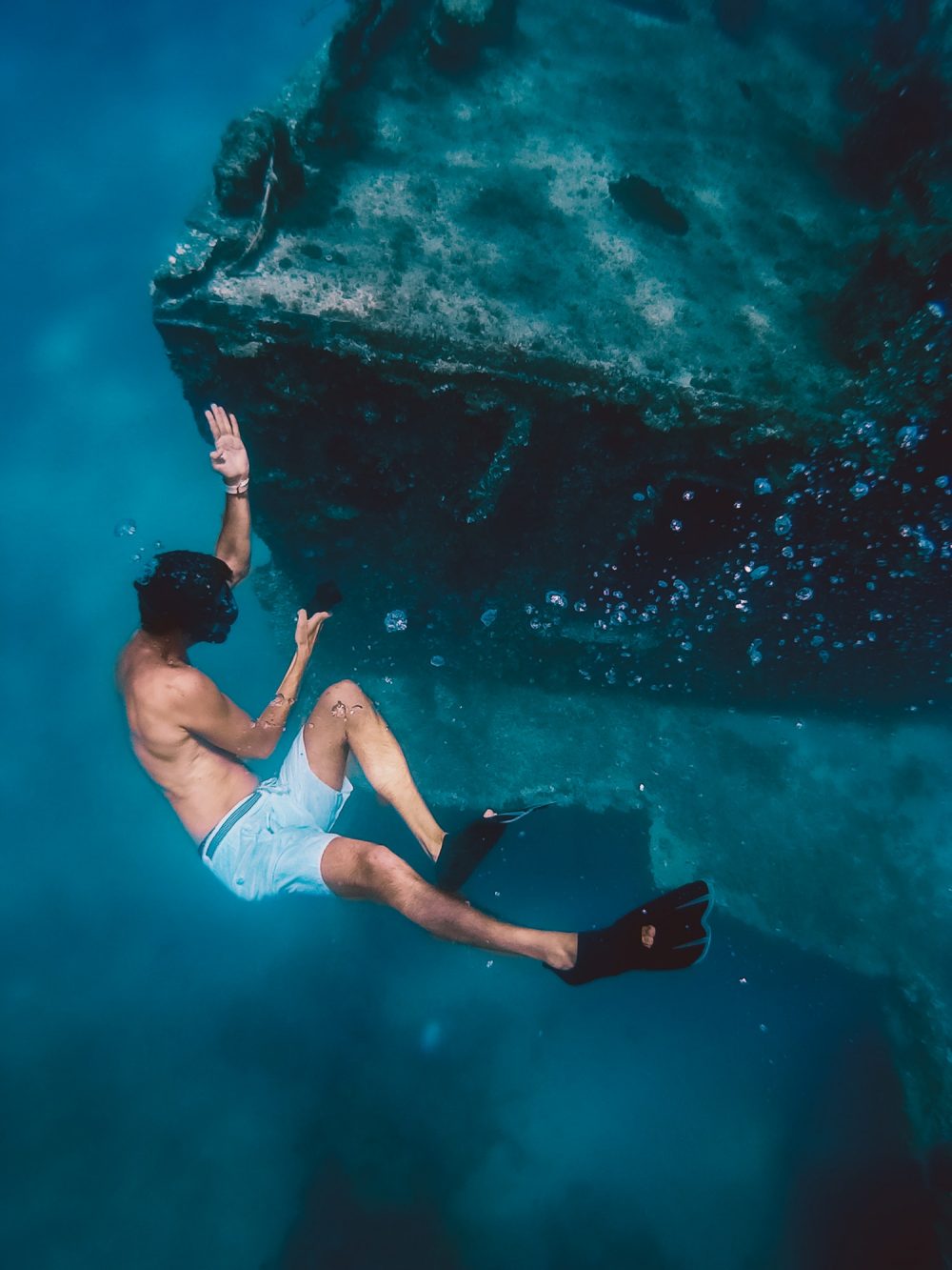 boy-snorkels-next-to-a-ship-wreck-submerged-in-the-ocean.jpg